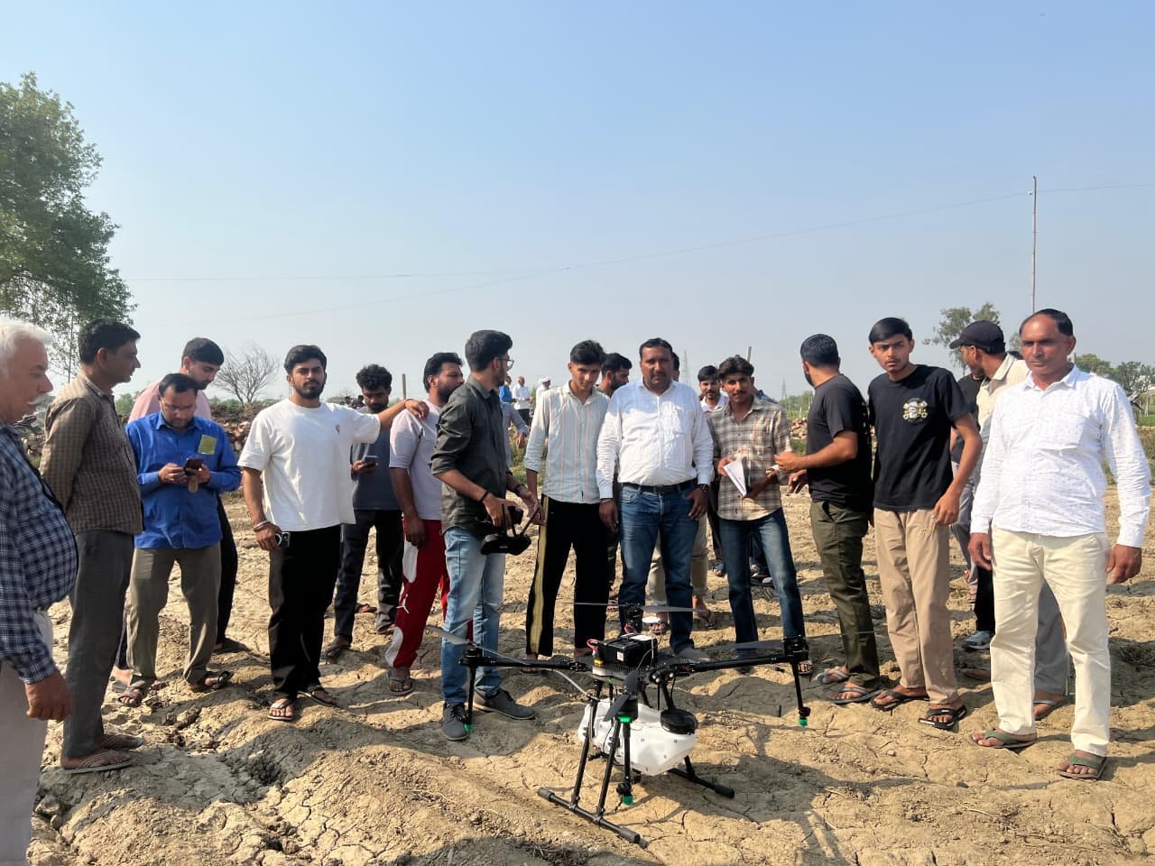 Farmers and pilots observing Aerocarrier agriculture drone field testing